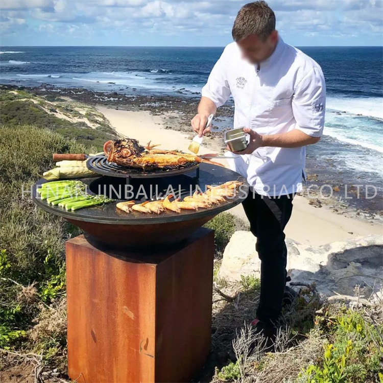 Using a Corten steel wood-fired BBQ grill outdoors