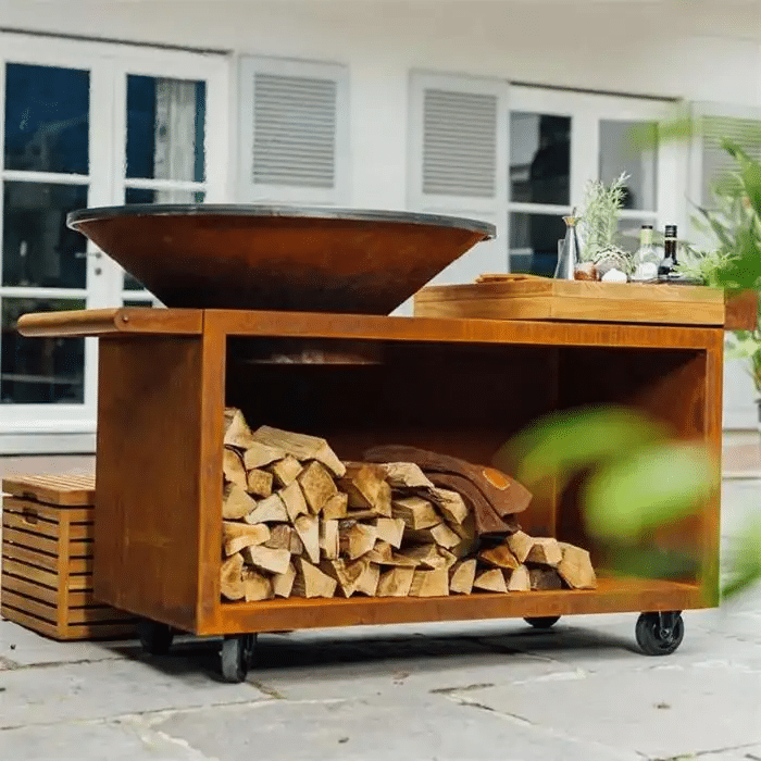 Corten steel wood-fired BBQ grill in an outdoor cooking area